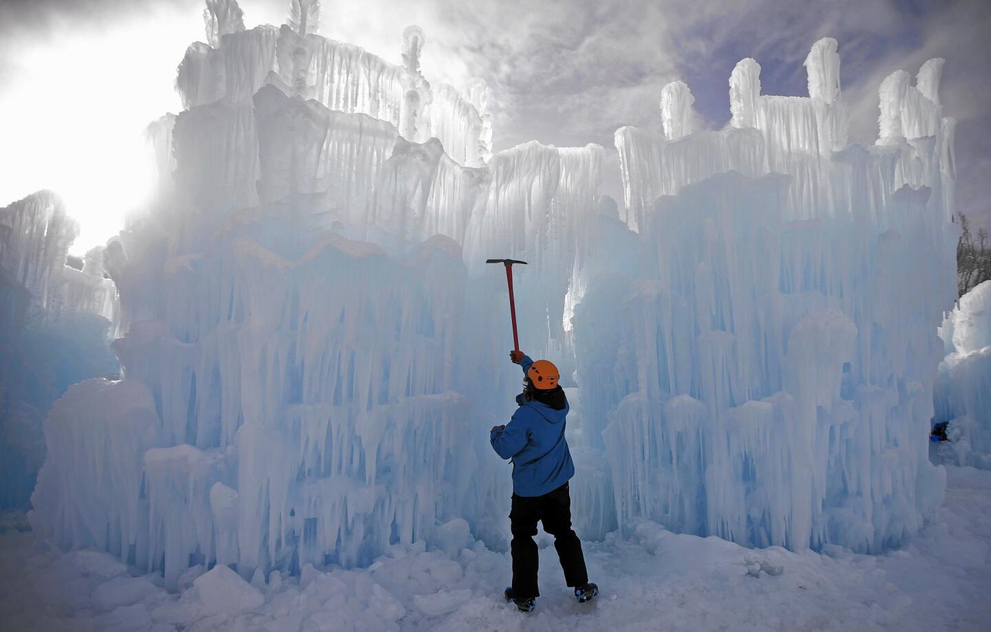 A worker helps sculpt the Ice Castles creation in Midway, Utah. Hundreds of thousands of icicles make up the thick walls, jagged mazes and fountains of the castle.
