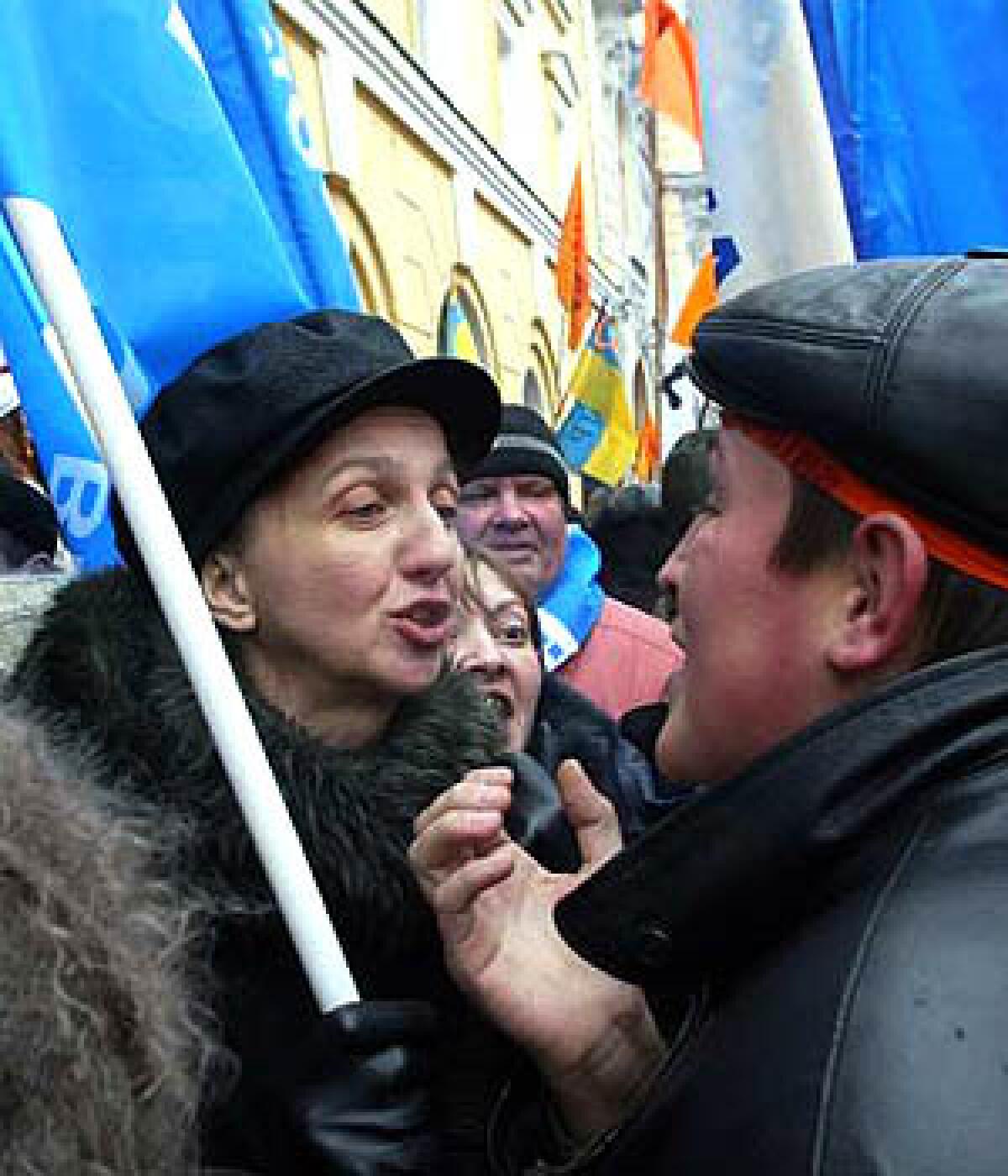 Supporters of Prime Minister Viktor Yanukovich argue with a Viktor Yushchenko backer, right, in Kiev.