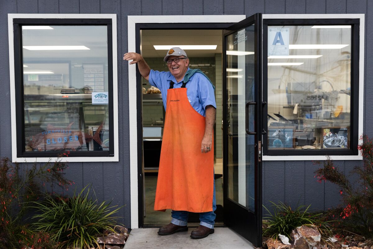 Tommy Gomes stands at the door of TunaVille Market and Grocery in Point Loma.