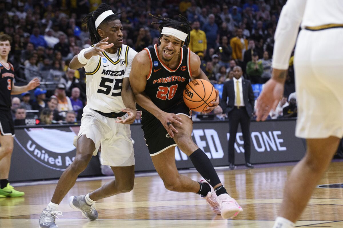 Princeton forward Tosan Evbuomwan (20) drives against Missouri guard Sean East II (55) during the second half of a second-round college basketball game in the men's NCAA Tournament in Sacramento, Calif., Saturday, March 18, 2023. Princeton won 78-63. (AP Photo/Randall Benton)