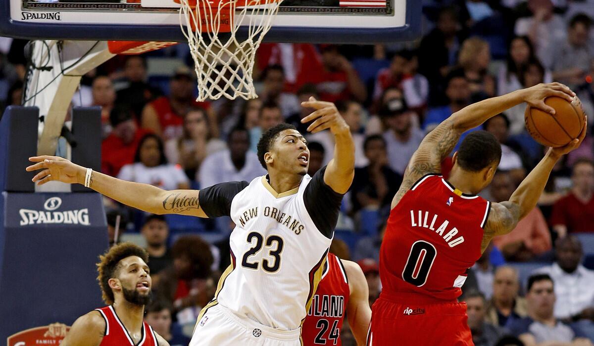 New Orleans Pelicans forward Anthony Davis (23) fails to keep a rebound away from Portland Trail Blazers guard Damian Lillard (0) during the the first half on Friday.
