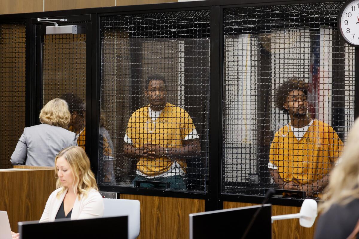 Malachi Darnell, Leroy McCrary and Jaden Cunningham wait in a screened room during a court appearance.