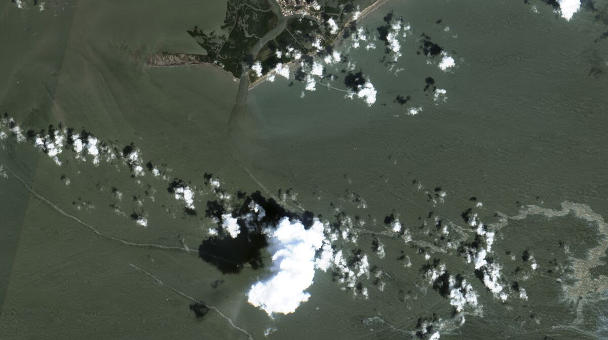 In a satellite image provided by Maxar Technologies, an oil slick is shown on Sept. 2, 2021 south of Port Fourchon, La. as a result of Hurricane Ida. U.S. industrial production slowed in August to a 0.4% gain in August as the shutdowns caused by Hurricane Ida took a toll on manufacturing activity. The Federal Reserve reported Wednesday, Sept. 15, 2021 that plant closures forced by Ida for petrochemicals, petroleum refining and other operations along the Gulf Coast had shaved 0.3 percentage point from the output figure. The small August gain was just half the 0.8% output increase in July. (Maxar Technologies via AP)