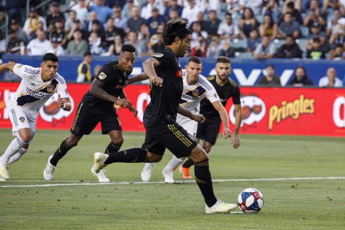 LAFC forward Carlos Vela (10) takes a penalty kick to score a goal during the first half of a match against the Galaxy on July 19, 2019 in Carson.