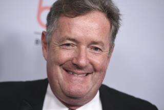 Piers Morgan smiles in a black suit at the 2019 BAFTA Los Angeles Britannia Awards at the Beverly Hilton Hotel