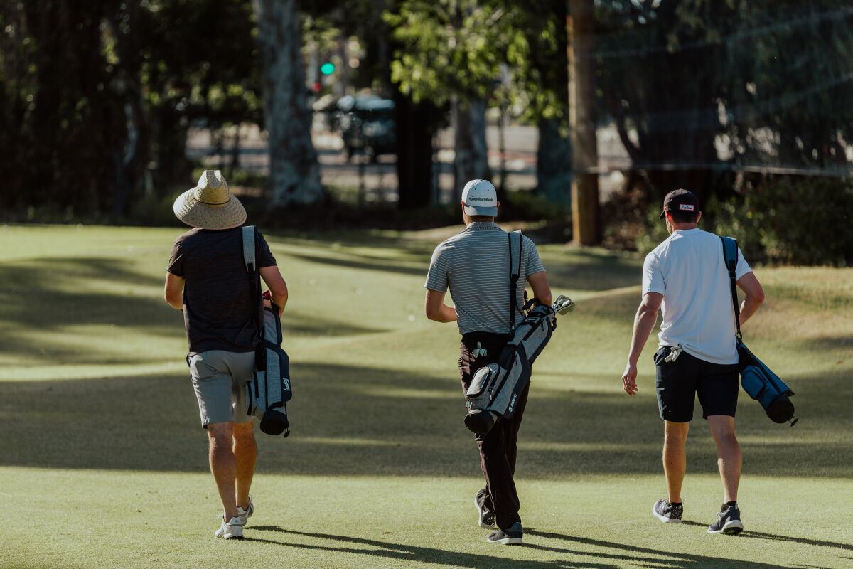 Golfers tote the lightweight Sunday Golf bag on the course.
