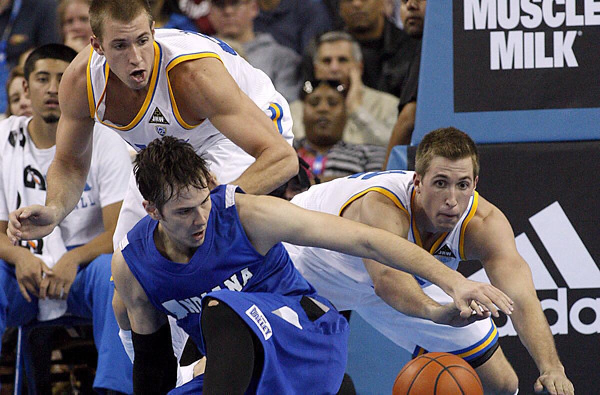UCLA forwards Travis, left, and David Wear battle for a loose ball against Indiana State forward R.J. Mahurin during a game last season at Pauley Pavilion.
