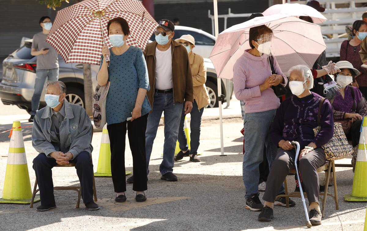 Chinatown seniors wait  to be vaccinated