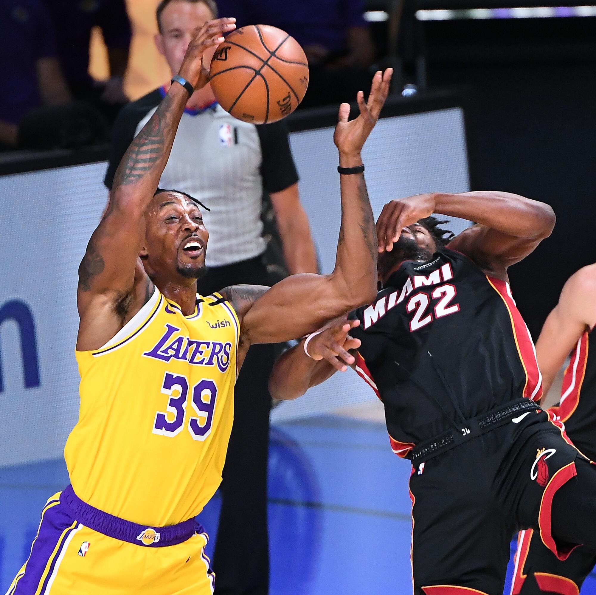 Lakers center Dwight Howard battles Heat forward Jimmy Butler for a rebound during Game 1.