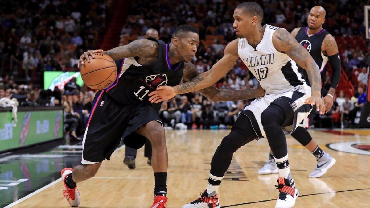 Clippers guard Jamal Crawford works against Miami guard Rodney McGruder during a game in Miami on Dec. 16.
