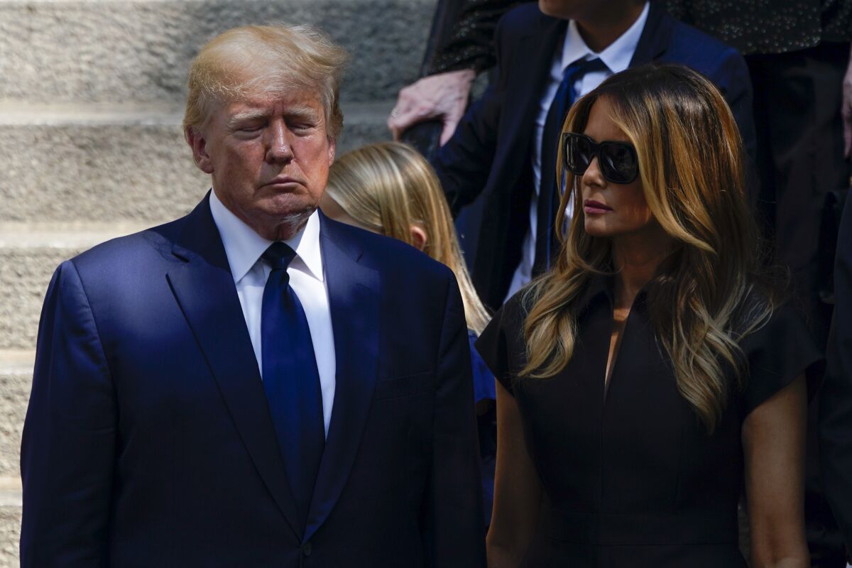 Former President Donald Trump, left, and his wife Melania Trump, stand outside St. Vincent Ferrer Roman Catholic Church after the funeral of Ivana Trump, Wednesday July 20, 2022, in New York. (AP Photo/Julia Nikhinson)