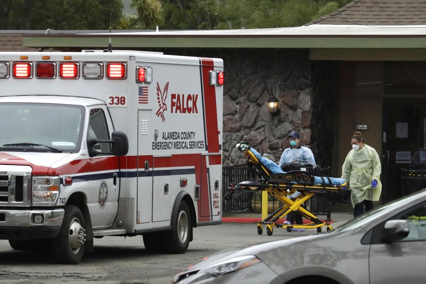 EMT's move a stretcher at the Gateway Care and Rehabilitation Center on Thursday, April 9, 2020, in Hayward, Calif. (AP Photo/Ben Margot)