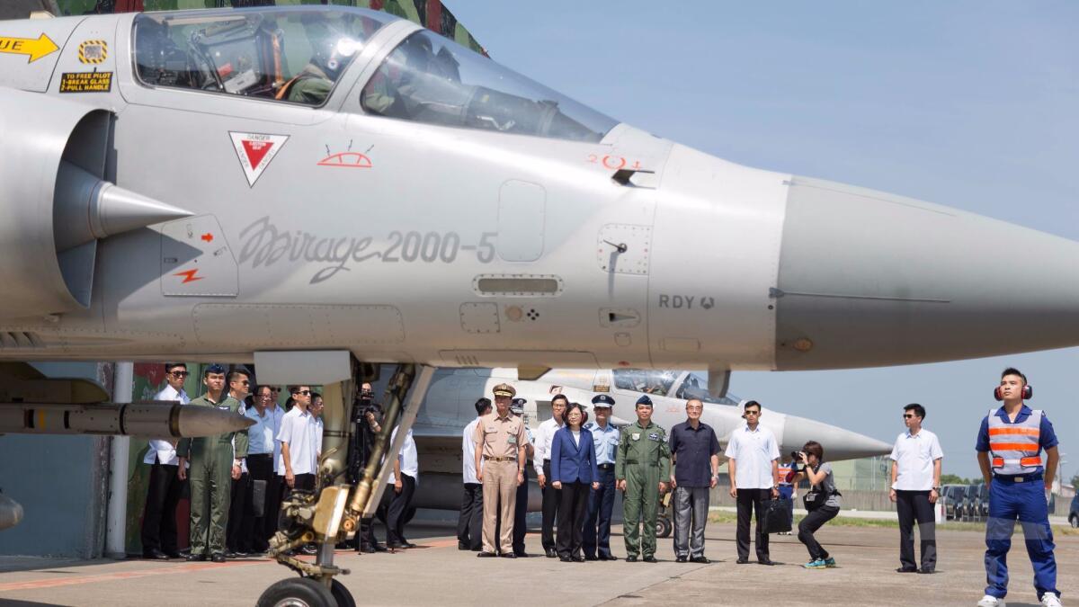 A handout photo made available by the Taiwan Military News Agency on Nov. 7 shows Taiwanese President Tsai Ing-wen, center, in blue jacket, inspecting Mirage 2000-5 jets on a training flight in southern Taiwan.