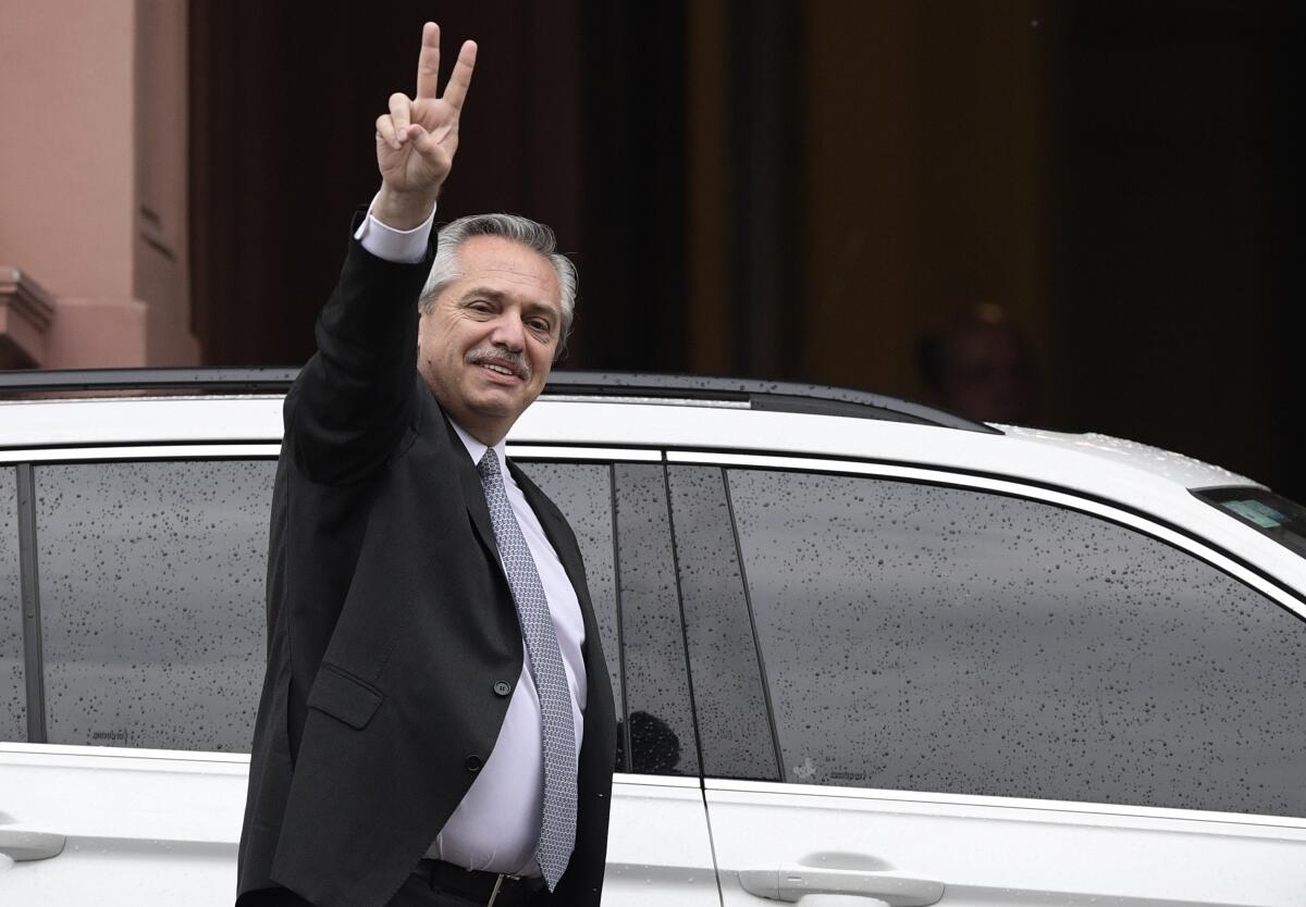 Argentina's president-elect Alberto Fernández flashes the "V" sign as he leaves the Casa Rosada presidential house Oct. 28 after a meeting with President Mauricio Macri.