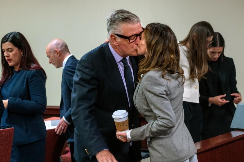 Actor and producer Alec Baldwin kisses his wife Hilaria in First District Court 