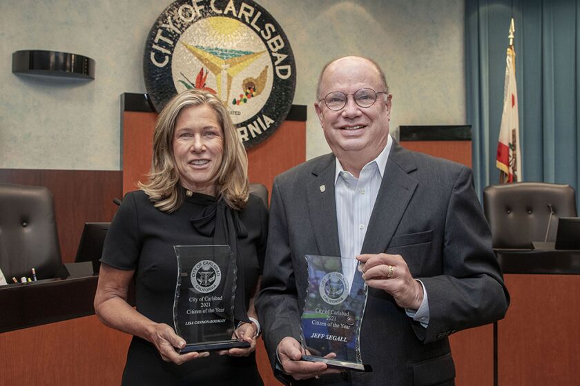 July 26, 2022_ At a special Carlsbad City Council meeting Lisa Cannon-Rodman and Jeff Segall hold their awards they received for being chosen as Carlsbad 2021 Citizens Of The Year.