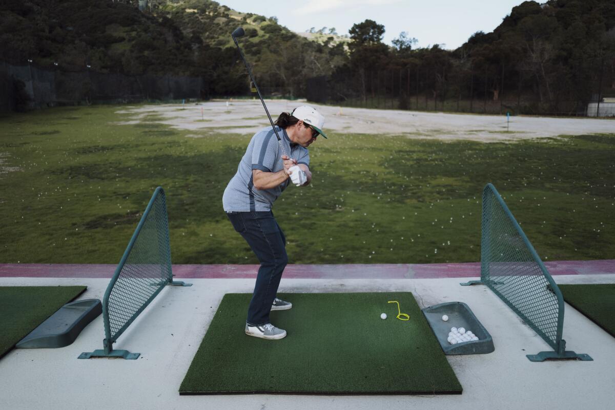 Dave Fink practices golfing.