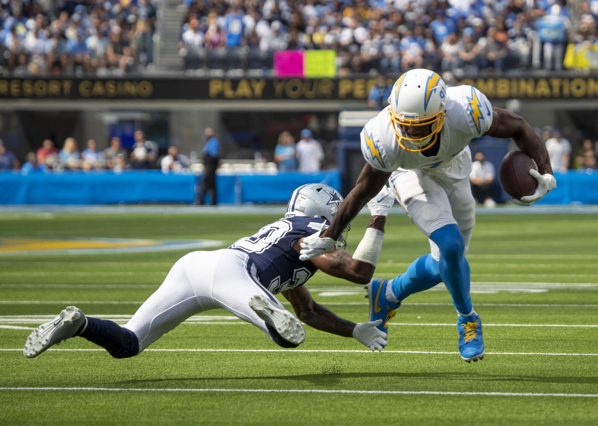 Chargers wide receiver Mike Williams avoids a tackle by Dallas Cowboys cornerback Anthony Brown.