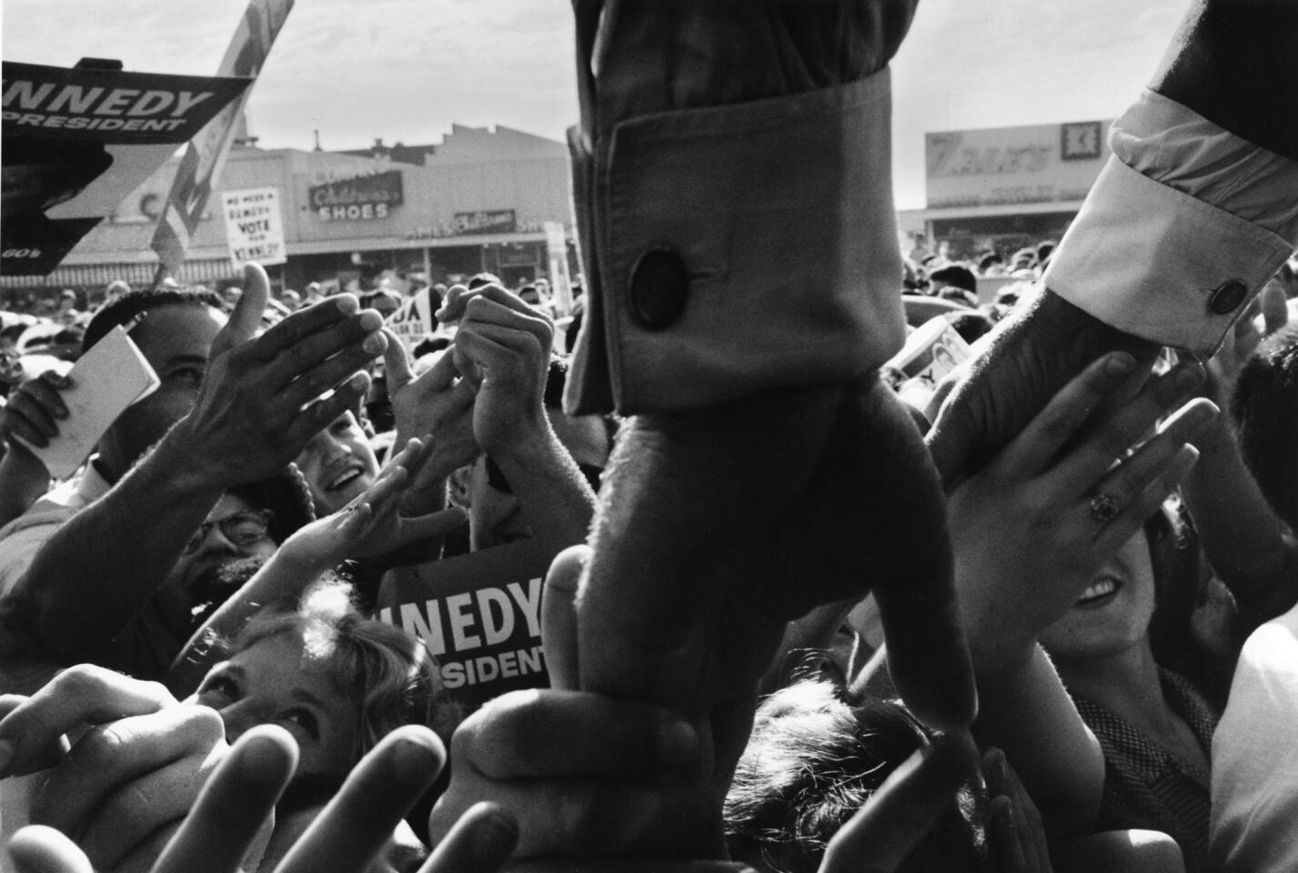 "John F. Kennedy reaching into a crowd of supporters, North Hollywood, California," 1960. This image is part of "A Bystander's View of History" exhibition at the International Center of Photography.