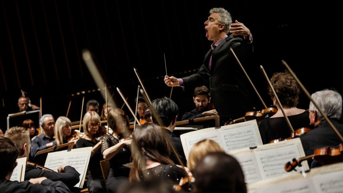 David Lockington leads the the Pasadena Symphony in April. A new contract calls for a 14.5% increase in the minimum wage scale over five years.