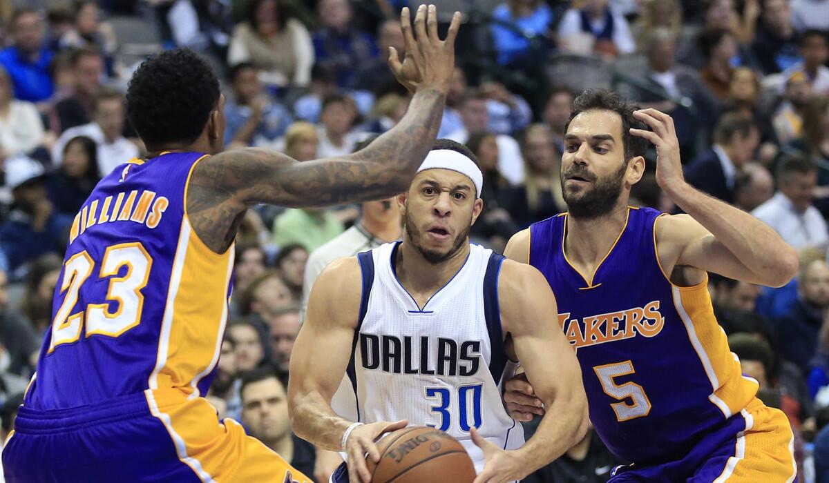 Dallas Mavericks guard Seth Curry (30) looks inside as Lakers guards Louis Williams (23) and Jose Calderon (5) defend during the second half Sunday.