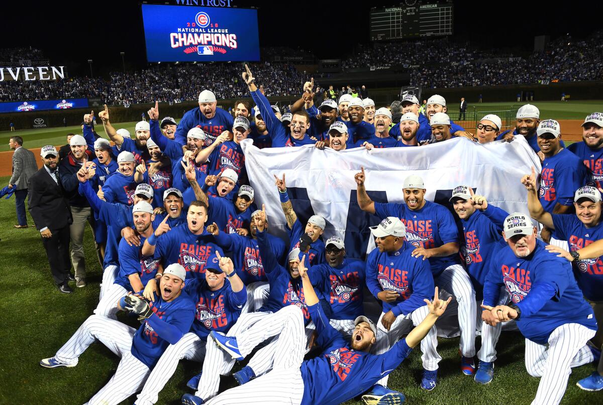 Cubs players and coaches celebrate on the field at Wrigley Field after winning the National League Championship Series against the Dodgers in Game 6.