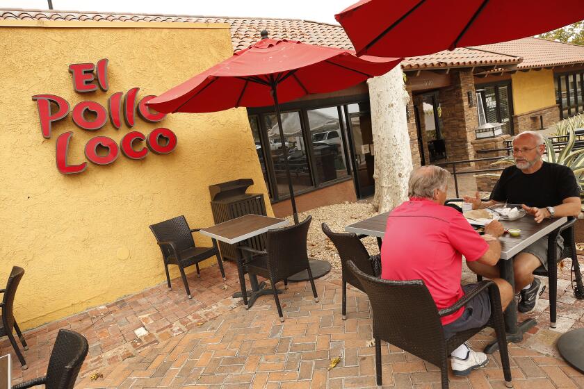AGOURA HILLS, CA - AUGUST 18: Steve Kopstein, left, and Michael Friedman enjoy lunch at the El Pollo Loco restaurant in Agoura Hills on August 18, 2021. Michaela Mendelsohn, CEO of Pollo West Corp, an Agoura Hills-based franchise company for Pollo Loco owns six restaurants with 200 employees in LA and Ventura Counties. When the pandemic hit in March 2020, Mendelsohn laid off 25 workers but was able to rehire them within weeks thanks to a federal loan. Her business lost sales at the beginning of the pandemic but revenue is now 10% above pre-pandemic levels. Five of her 6 outlets have drive-through which allowed business to continue. She has avoided labor shortages by raising wages, giving bonuses to employees who kept working through the pandemic, and expanding paid time off. Nonetheless, she is concerned that new COVID variants, the failure of many to get vaccinated, expiring unemployment benefits and expiring eviction protections could set back California's economy again. El Pollo Loco on Wednesday, Aug. 18, 2021 in Agoura Hills, CA. (Al Seib / Los Angeles Times).