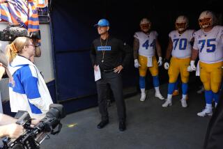 Chargers head coach Jim Harbaugh waits to lead team out of tunnel in Denver last week.