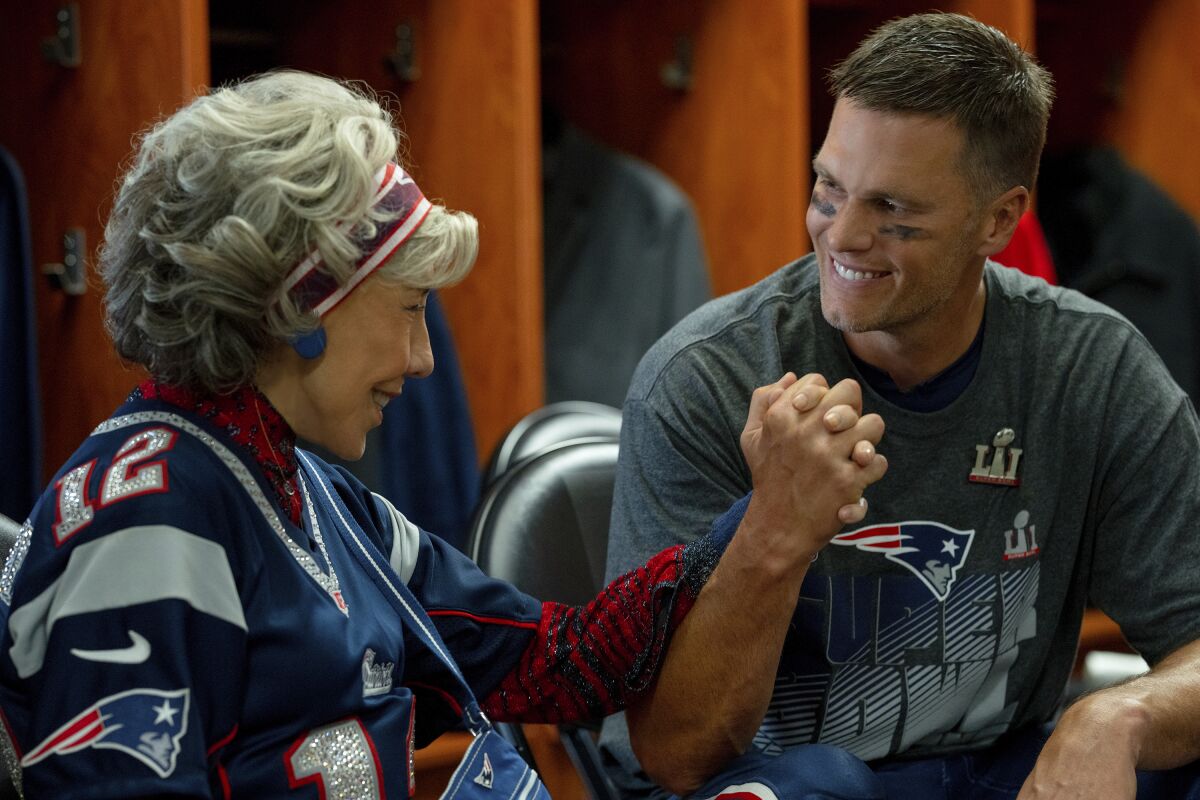 This image released by Paramount shows Lily Tomlin, left, and Tom Brady in a scene from "80 for Brady." (Scott Garfield/Paramount Pictures via AP)