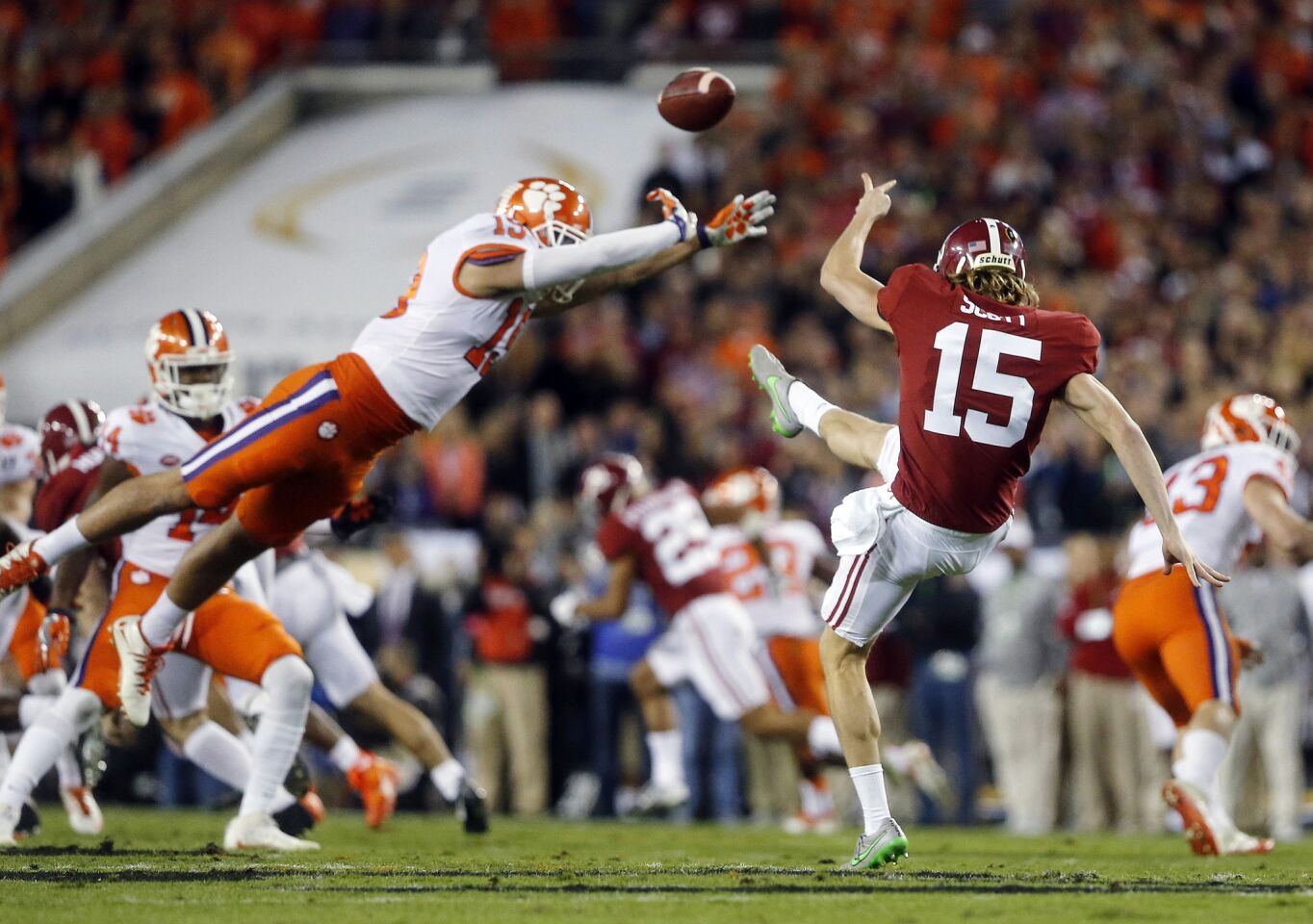 Clemson safety Tanner Muse partially blocks the punt of Alabama's JK Scott during the first quarter.