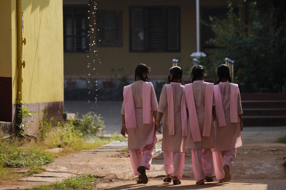 Indian students in uniform clothing walk inside the campus of a government-run junior college in Udupi, Karnataka state, India, Feb. 24, 2022. Muslim students in this southern Indian state have found themselves at the center of a debate over hijab bans in schools. The furor began in January when staffers at the college began refusing admission to girls who showed up in a hijab, saying they were violating the uniform code. (AP Photo/Aijaz Rahi)