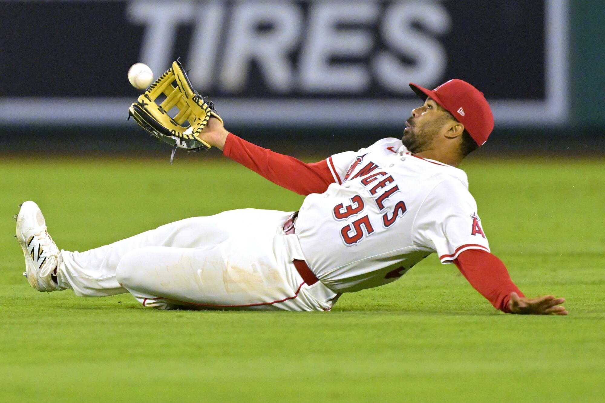 Angels right fielder LaMonte Wade Jr. makes a sliding catch during the eighth inning against the Washington Nationals.