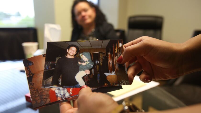 Brittany Glenn looks through pictures of her brother Brendon, who was shot and killed by a Los Angeles police officer last year in Venice, as their mother, Sheri Camprone, looks on. In the photo, Brendon Glenn is holding his son, Avery.