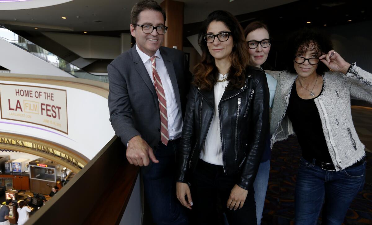 Portrait of some of the senior team behind the Los Angeles Film Festival, which announced a move to the ArcLight Cinemas: from left, Josh Welsh, Film Independent president; Roya Rastegar, director of programming; Jennifer Cochis, creative director; and Stephanie Allain, festival director, pictured at the festival's former headquarters at the Regal LA Live.