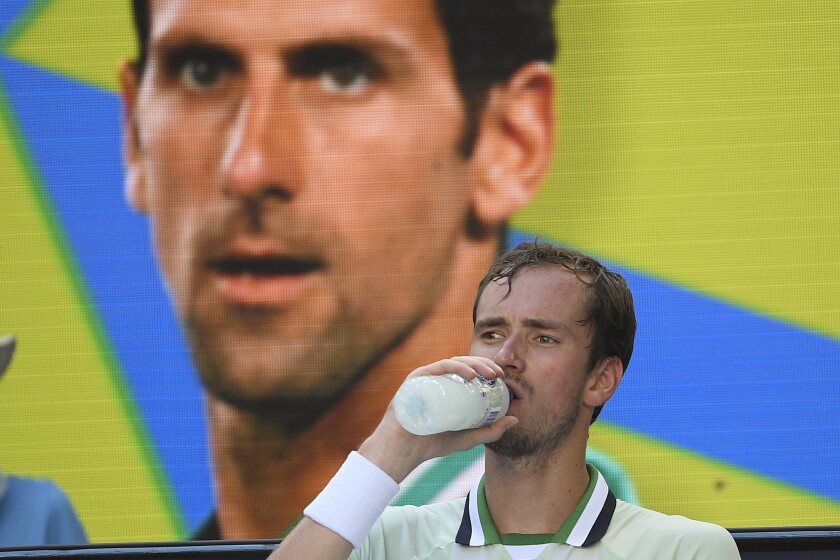 Daniil Medvedev of Russia takes a drink during a break in his third round match against Botic van de Zandschulp of the Netherlands at the Australian Open tennis championships in Melbourne, Australia, Saturday, Jan. 22, 2022. (AP Photo/Andy Brownbill)