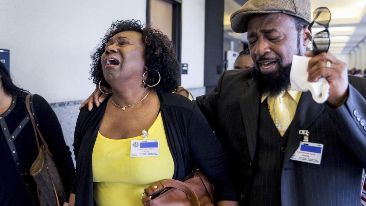 Kattie Jones and her husband, Clinton Jones Sr., father of Corey Jones, walk down the hall from the courtroom after Nouman Raja was found guilty in March.