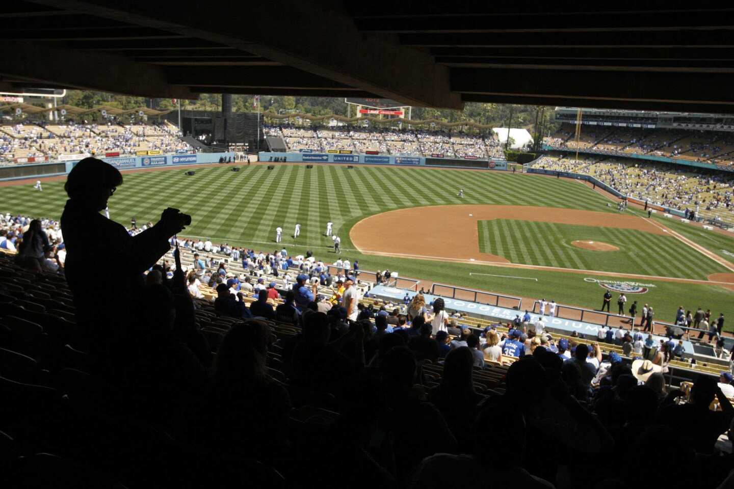 A baseball fan takes a picture of the field at Dodger Stadium before the start of Tuesday's home opener against the Pittsburgh Pirates.