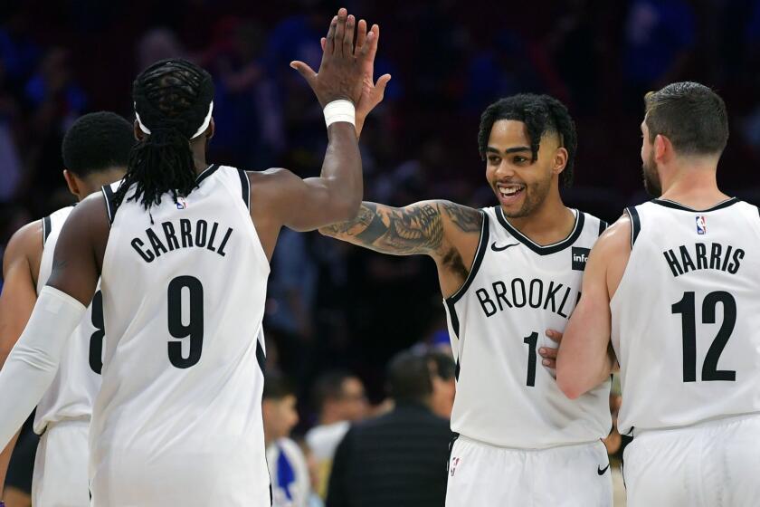 PHILADELPHIA, PA - APRIL 13: D'Angelo Russell #1 of the Brooklyn Nets celebrates with teammates DeMarre Carroll #9 and Joe Harris #12 after beating the Philadelphia 76ers 111-102 during Game One of the first round of the 2019 NBA Playoff at Wells Fargo Center on April 13, 2019 in Philadelphia, Pennsylvania. NOTE TO USER: User expressly acknowledges and agrees that, by downloading and or using this photograph, User is consenting to the terms and conditions of the Getty Images License Agreement. (Photo by Drew Hallowell/Getty Images) ** OUTS - ELSENT, FPG, CM - OUTS * NM, PH, VA if sourced by CT, LA or MoD **