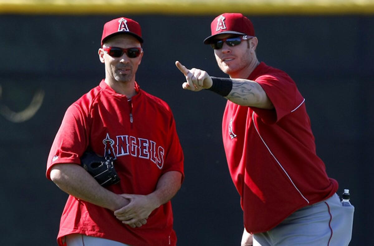 Angels slugger Josh Hamilton, right, shares some thoughts with new teammate Raul Ibanez during a spring workout last week in Tempe, Ariz.