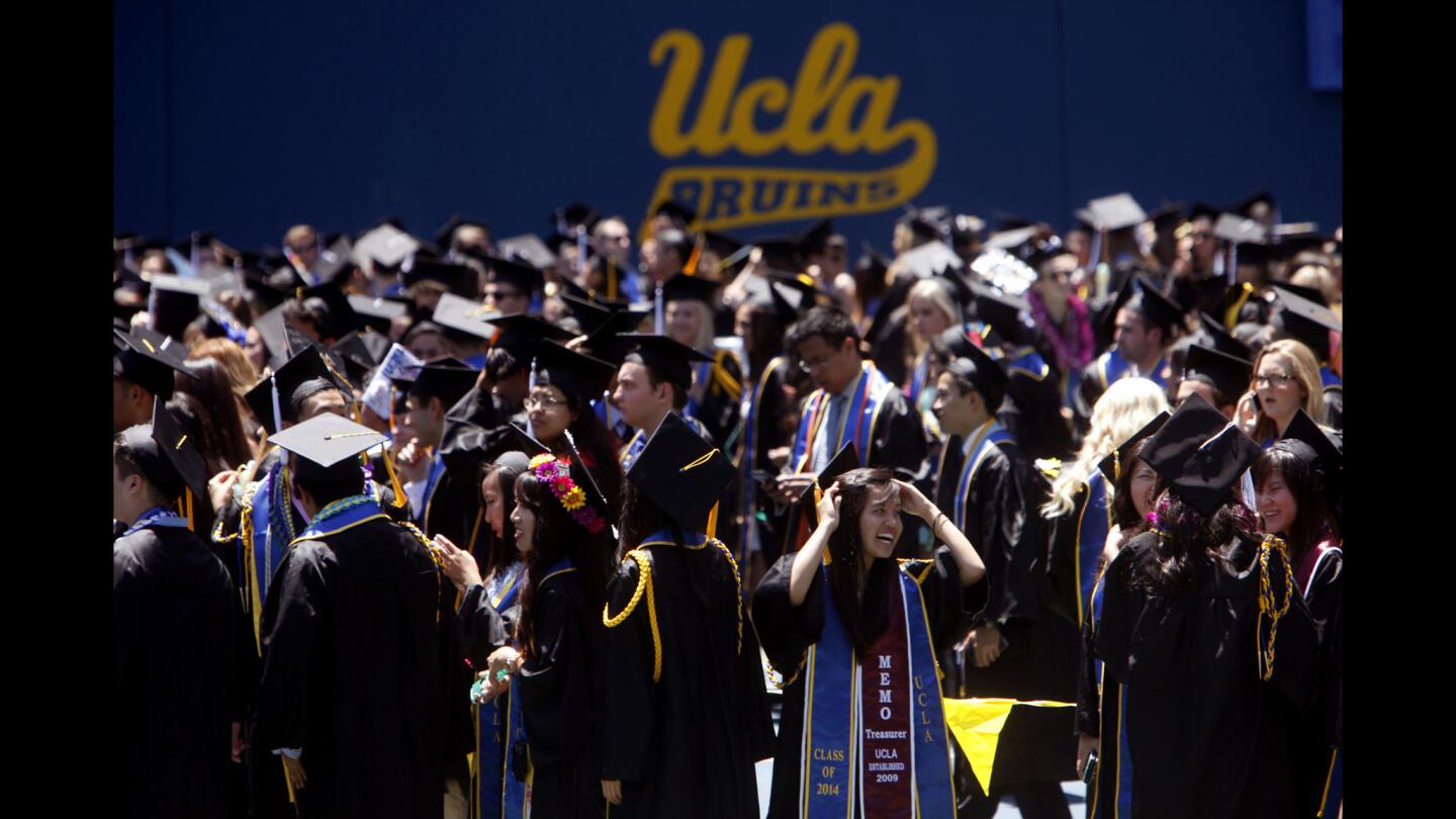 UCLA students make their way toward Pauley Pavilion for graduation ceremonies Friday. UCLA alumnus Randy Schekman, the 2013 Nobel Prize winner in physiology or medicine, delivered the keynote speech.
