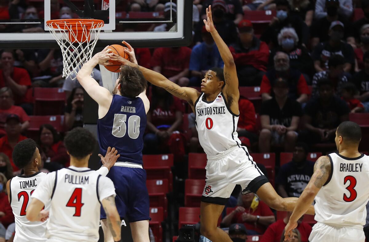 San Diego State's Keshad Johnson blocks a shot by Nevada's Will Baker in the first meeting between the Aztecs and Wolf Pack.