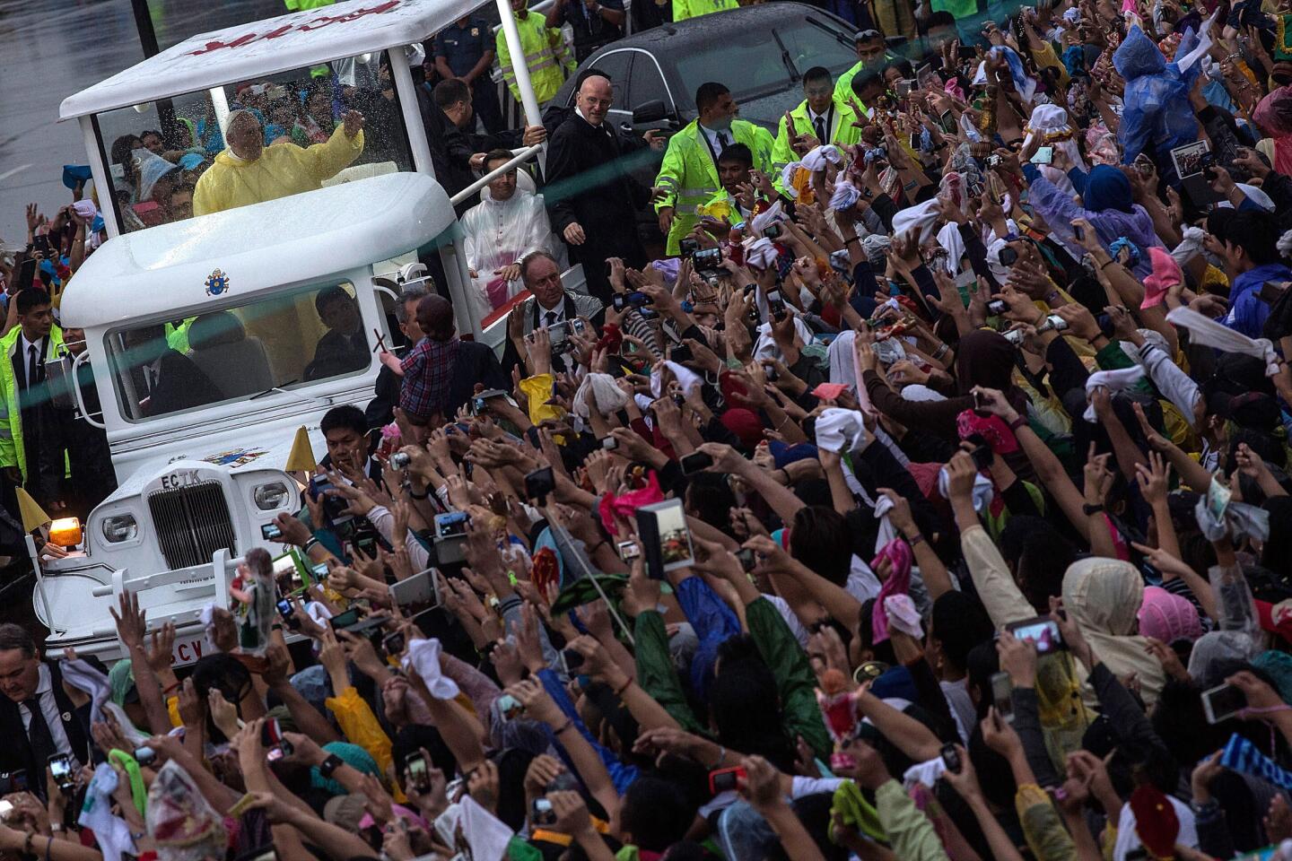Pope Francis waves to the crowd after celebrating Mass at Manila's Rizal Park.
