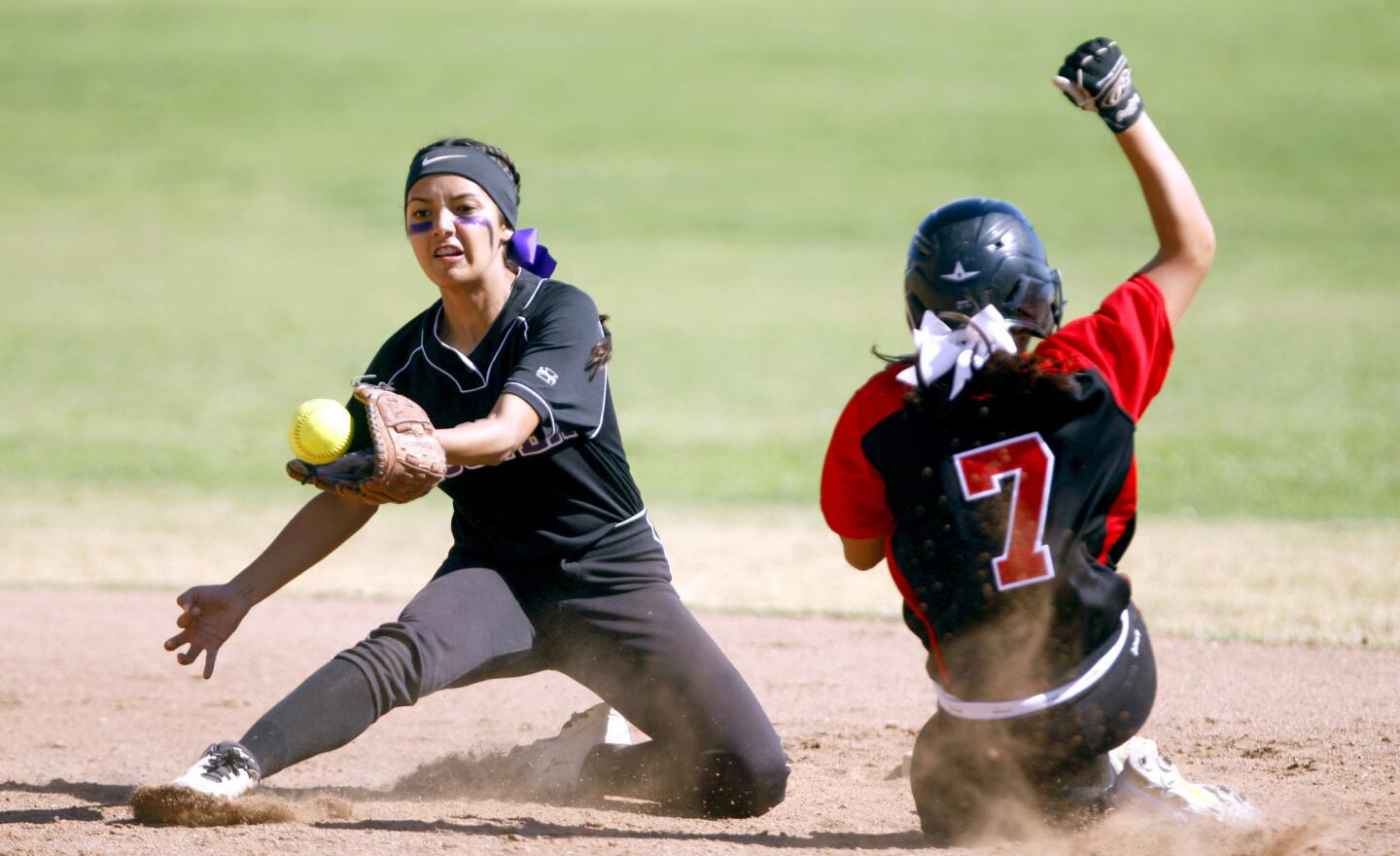 Glendale High School's #7 Sammy Fabian steals second base as Hoover High School's #20 Samantha Serrano receives the ball in a Pacific League softball game in Glendale on Thursday, April 20, 2017.