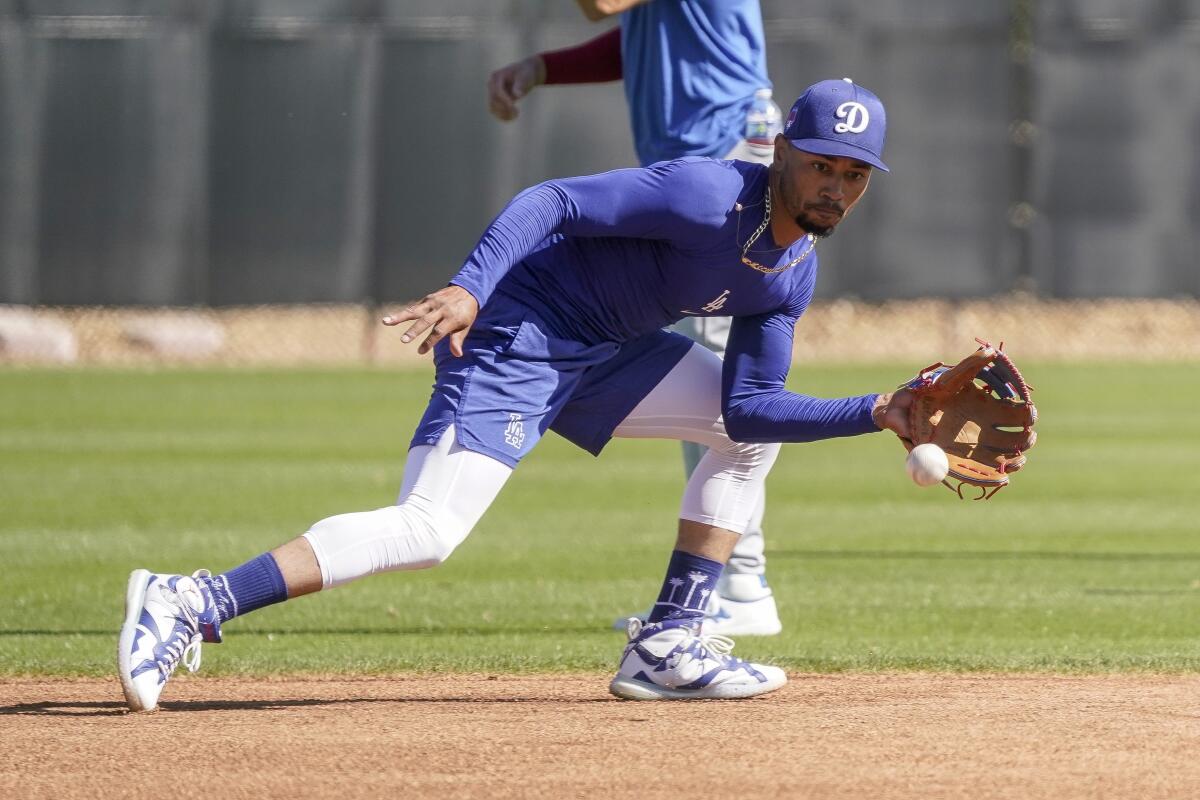 Dodgers shortstop Mookie Betts fields a grounder during spring training workouts at Camelback Ranch in Phoenix on Monday.
