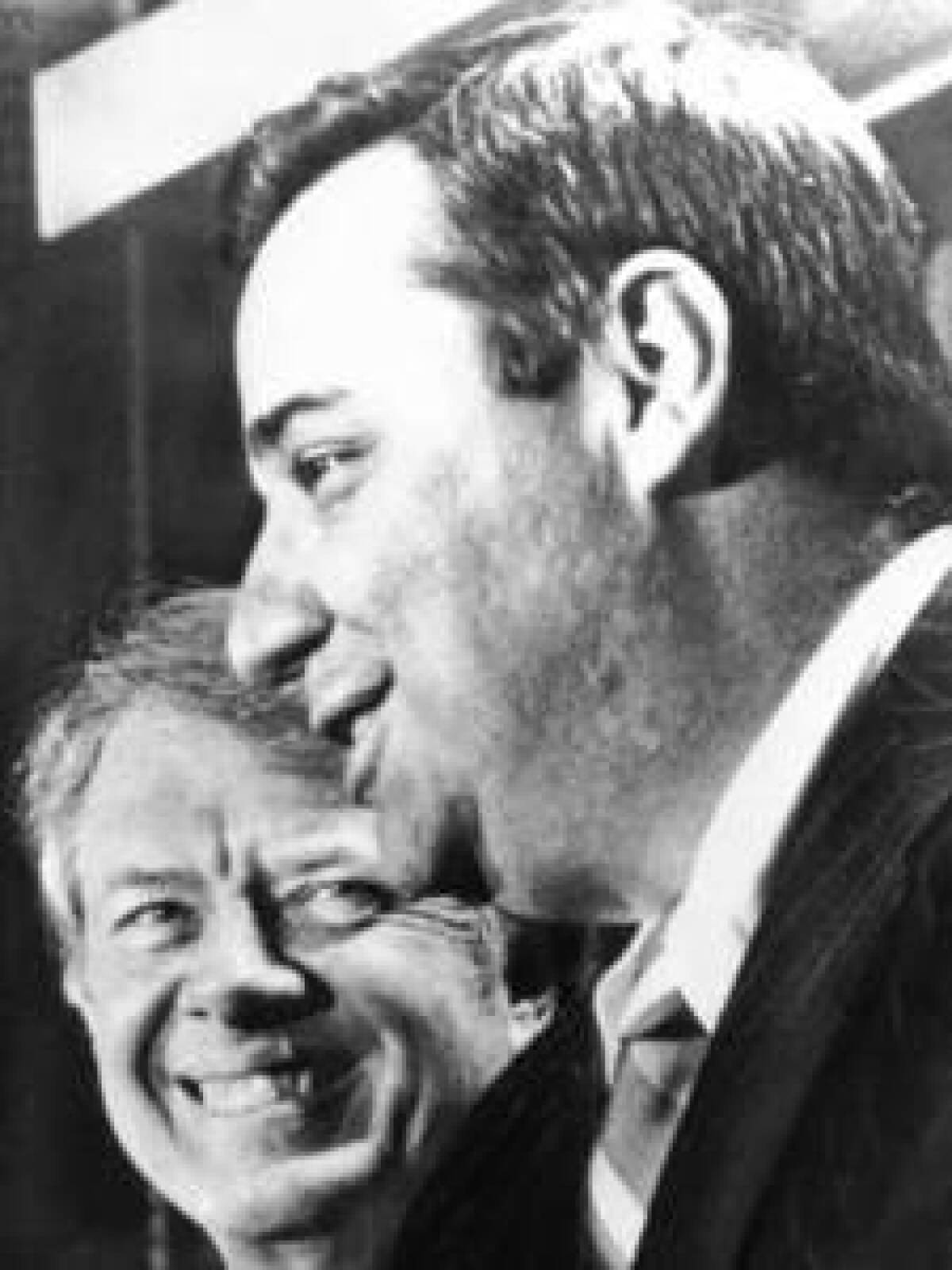 In this photo from 1976, President Carter, left, listens as Bert Lance, his choice to head the Office of Management and Budget, addresses a news conference in Plains, Ga. Lance, a banker and close ally of Carter, has died at the age of 82.