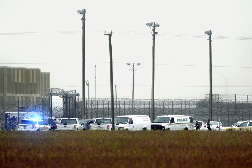FILE - In this Oct. 12, 2017, file photo, police vehicles are seen outside Pasquotank Correctional Institution in Elizabeth City, N.C. Closing arguments are expected next week in the trial of an inmate accused of murder in a deadly attempted breakout that left four North Carolina prison workers dead. The Virginian-Pilot reports jurors were shown a video interview Thursday, Oct. 17, 2019, in which Mikel Brady described striking a prison guard until she stopped moving during the Oct. 2017 escape attempt at the prison. (Thomas J. Turney/The Daily Advance via AP, File)