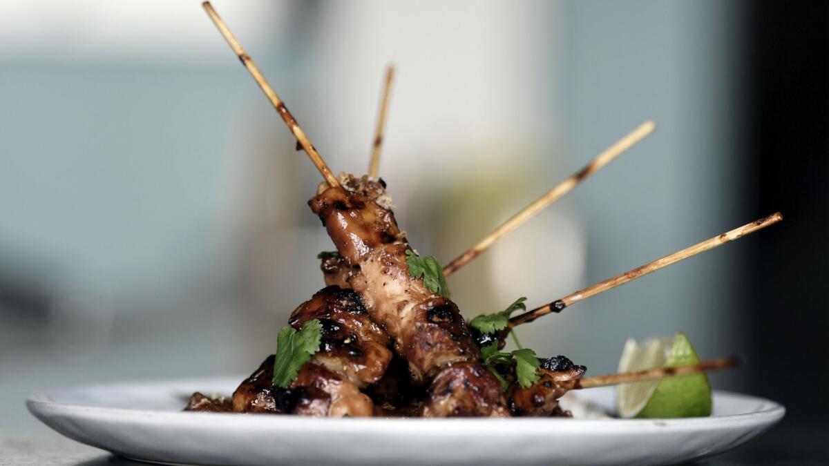 Sate Ayam: sweet soy-glazed grilled chicken skewers with peanut sauce.