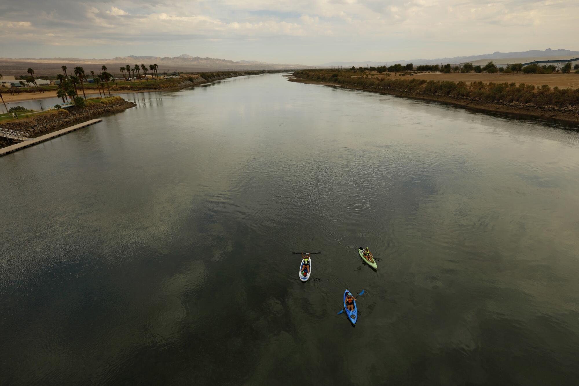 Kayakers float down the Colorado River through the Fort Mojave Reservation.