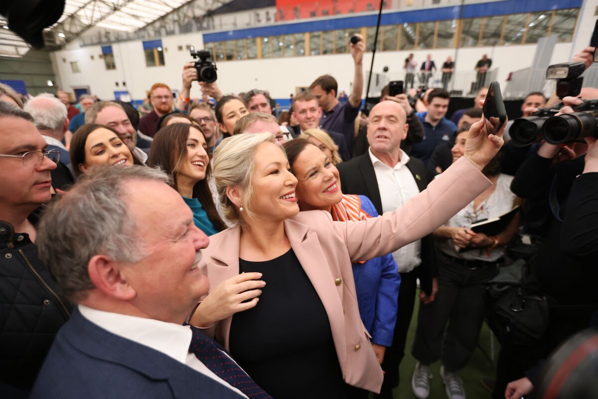 Sinn Fein's Michelle O'Neill, left, and party leader Mary Lou McDonald take a selfie at Medow Bank election count centre on Saturday, May, 7, 2022, in Magherafelt , Northern Ireland. (AP Photo/Peter Morrison)