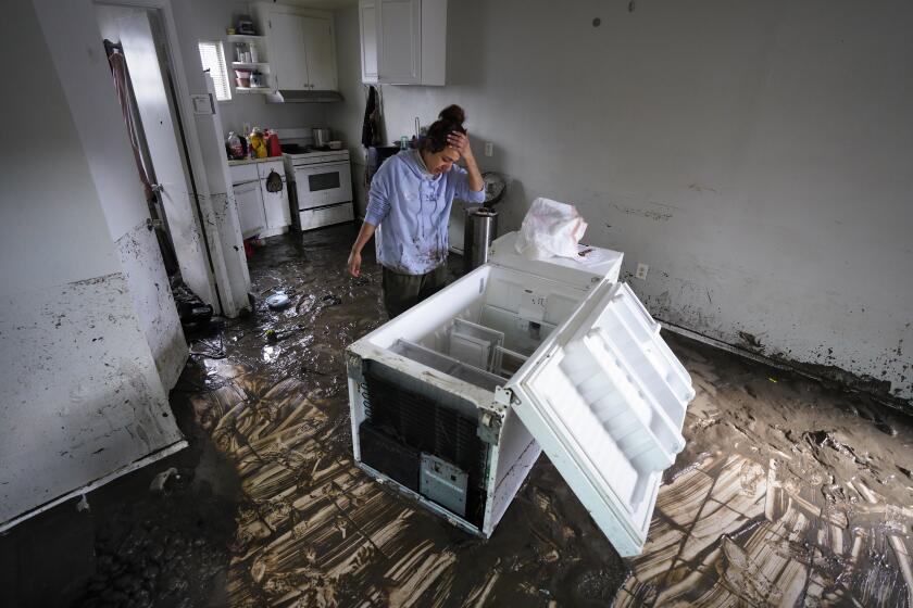 Karla Gomez Rodrigues (cq), 36, realized that the storm water and mud had contaminated the contents.